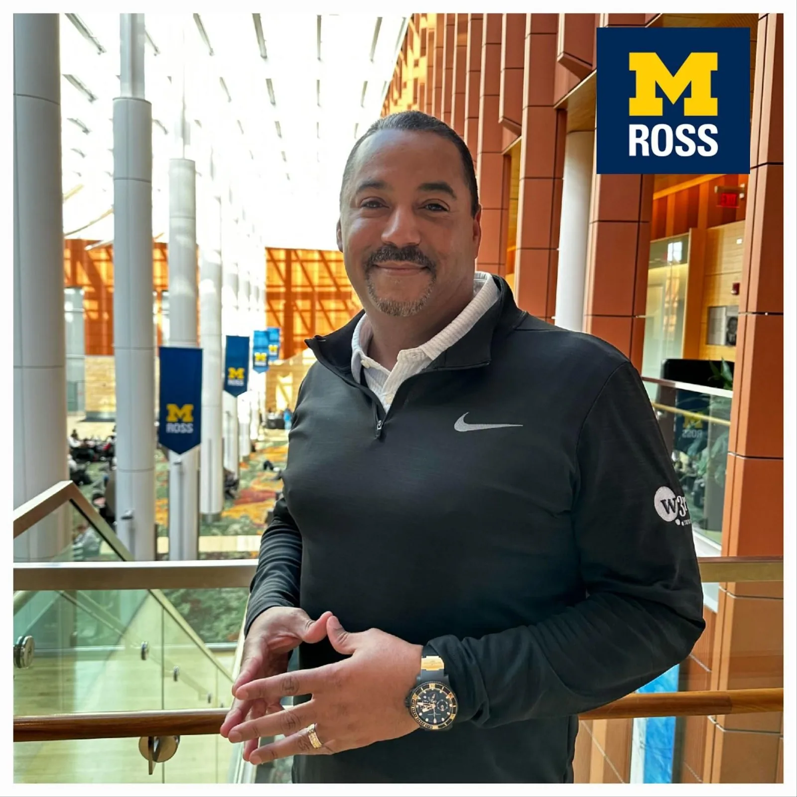 Eric in the Ross atrium with the Michigan Ross logo